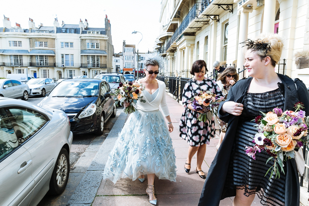 Emma and Marshy had a secret wedding in Brighton. Emma wore a bespoke blue dress by Suzanne Neville. Photography by Nick Tucker.