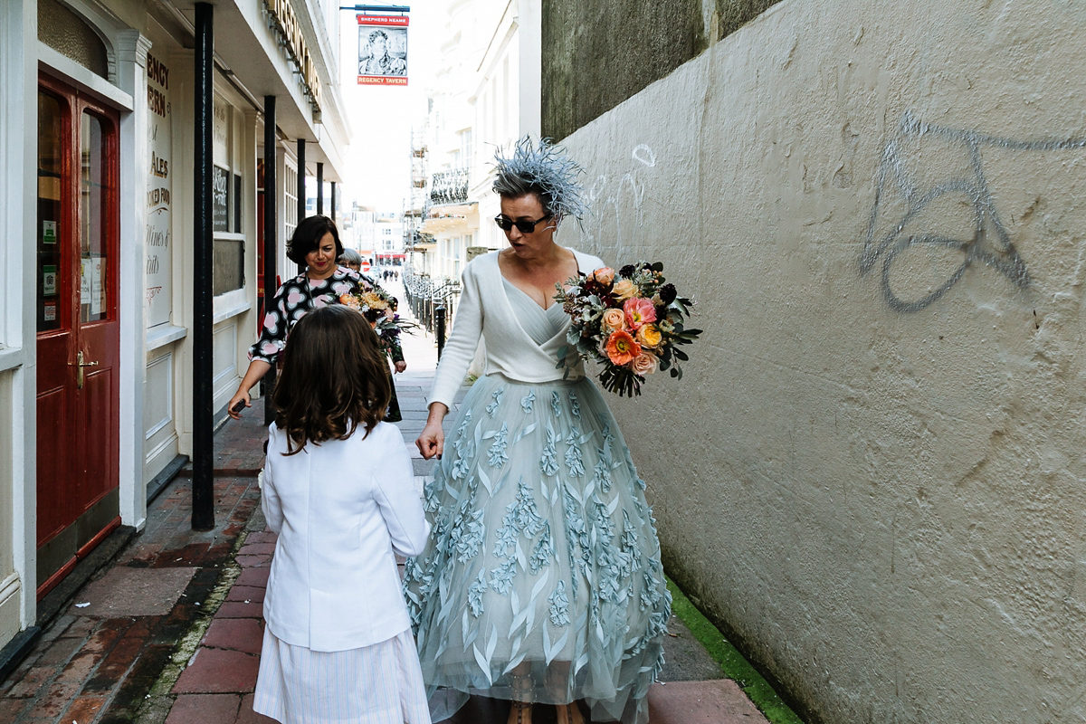 Emma and Marshy had a secret wedding in Brighton. Emma wore a bespoke blue dress by Suzanne Neville. Photography by Nick Tucker.