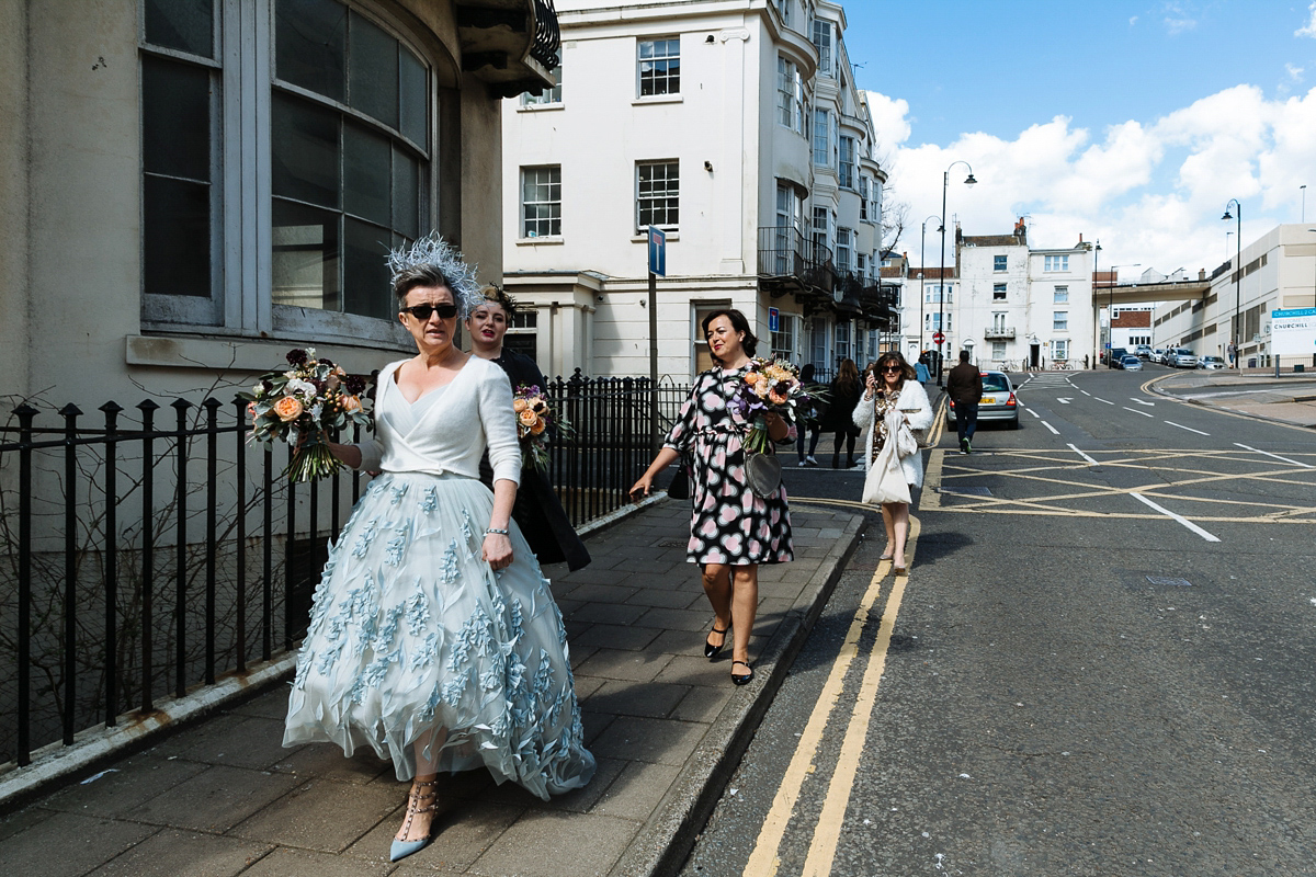 Emma and Marshy had a secret wedding in Brighton. Emma wore a bespoke blue dress by Suzanne Neville. Photography by Nick Tucker.