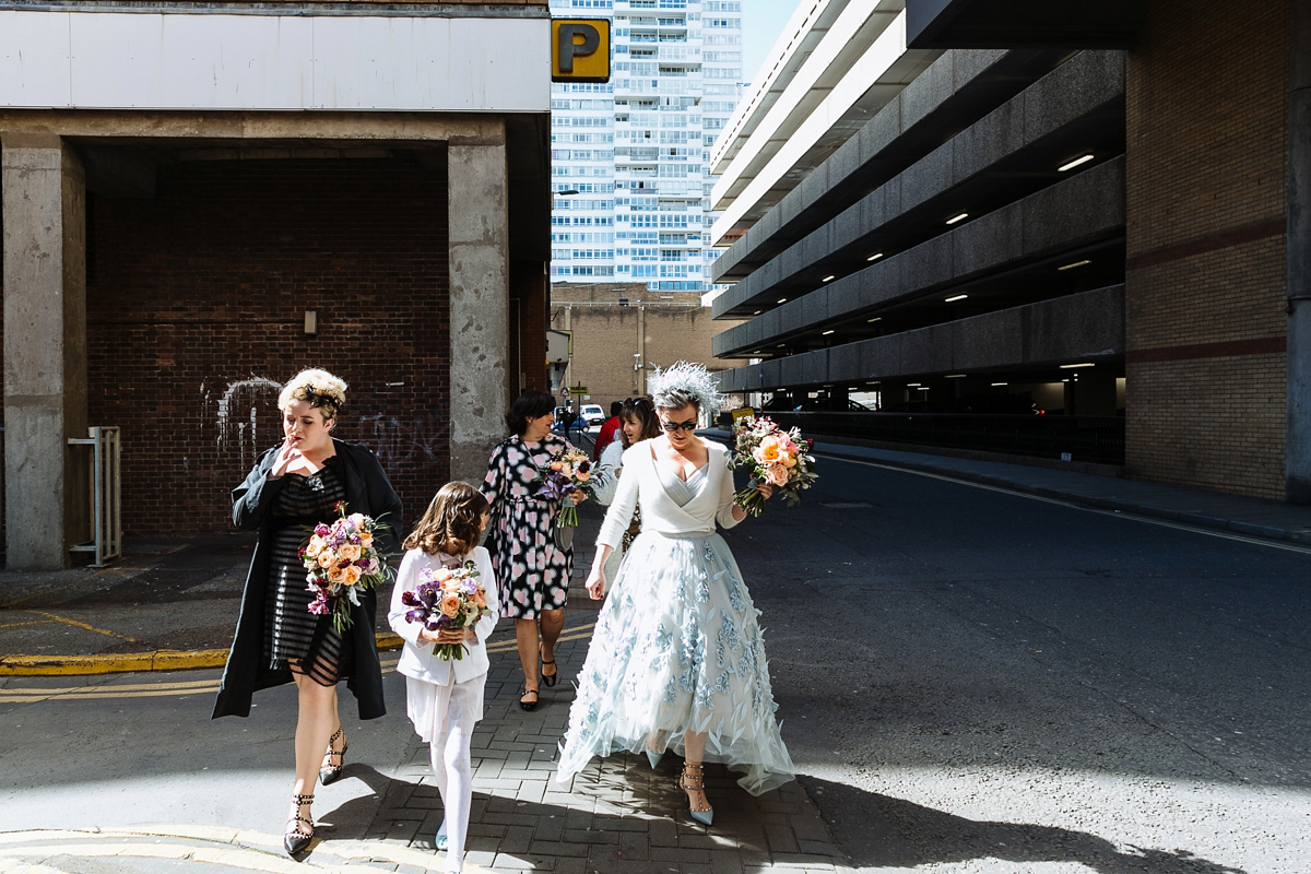 Emma and Marshy had a secret wedding in Brighton. Emma wore a bespoke blue dress by Suzanne Neville. Photography by Nick Tucker.