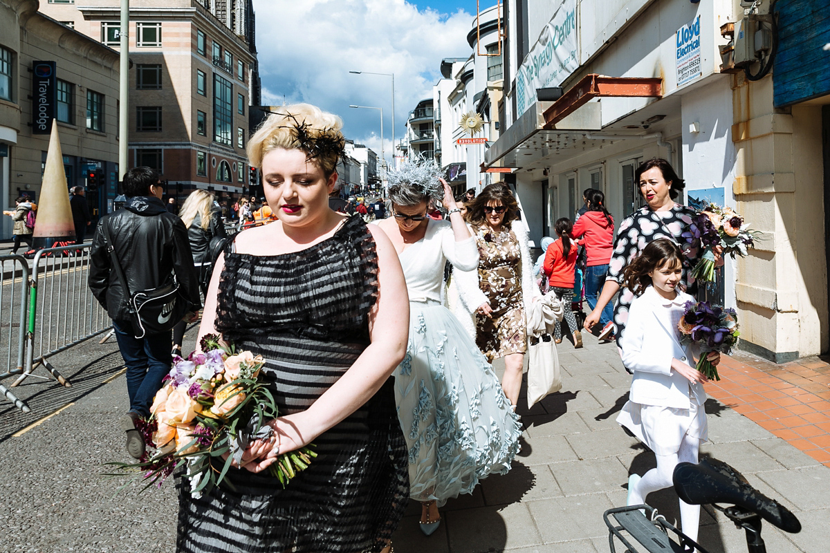 Emma and Marshy had a secret wedding in Brighton. Emma wore a bespoke blue dress by Suzanne Neville. Photography by Nick Tucker.