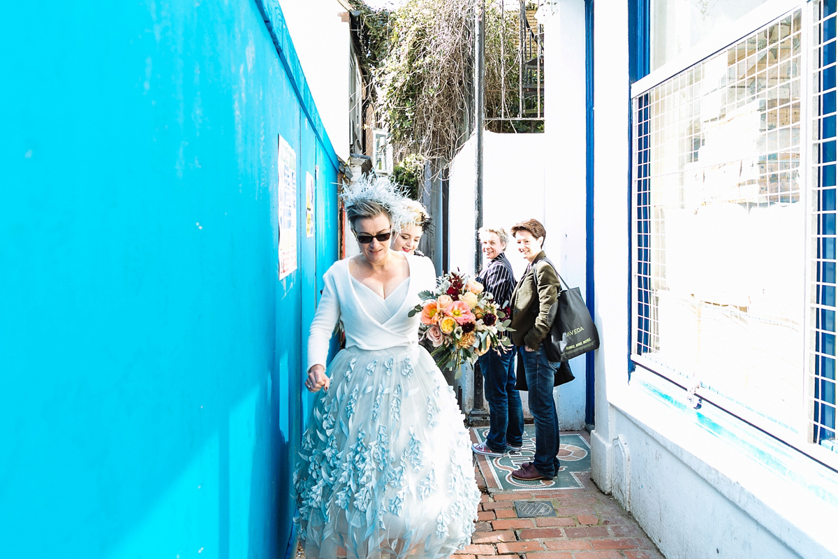 Emma and Marshy had a secret wedding in Brighton. Emma wore a bespoke blue dress by Suzanne Neville. Photography by Nick Tucker.