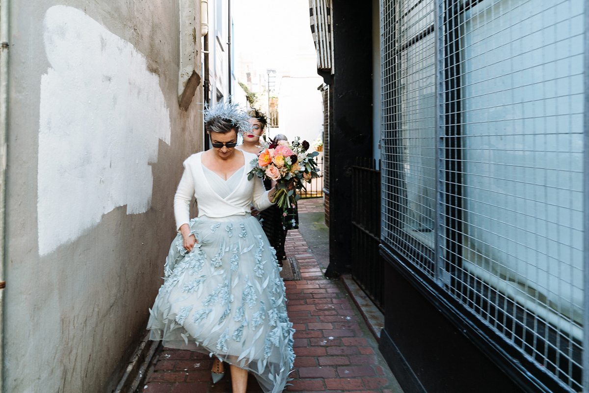 Emma and Marshy had a secret wedding in Brighton. Emma wore a bespoke blue dress by Suzanne Neville. Photography by Nick Tucker.