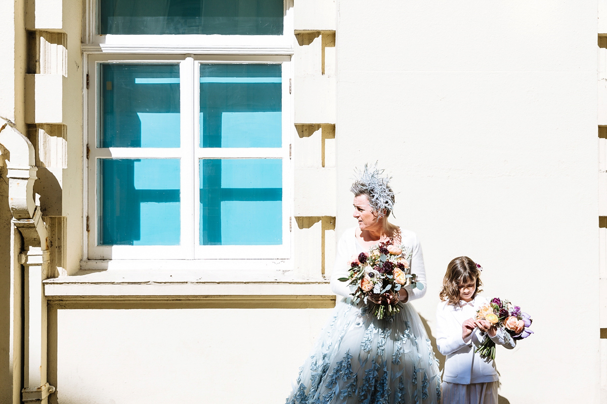 Emma and Marshy had a secret wedding in Brighton. Emma wore a bespoke blue dress by Suzanne Neville. Photography by Nick Tucker.