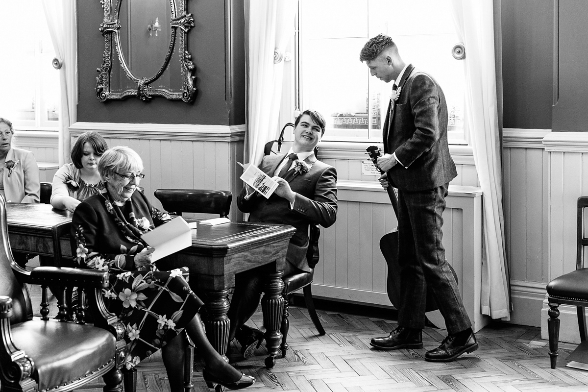 Emma and Marshy had a secret wedding in Brighton. Emma wore a bespoke blue dress by Suzanne Neville. Photography by Nick Tucker.