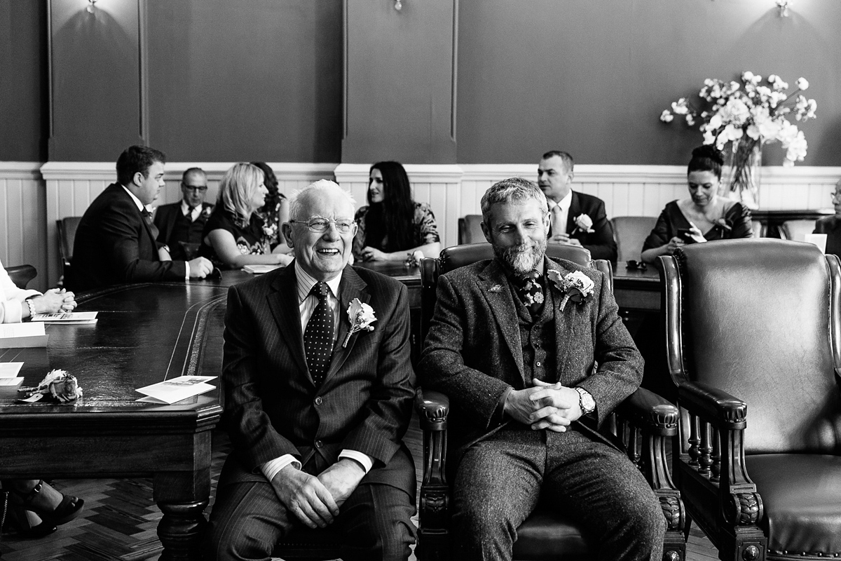 Emma and Marshy had a secret wedding in Brighton. Emma wore a bespoke blue dress by Suzanne Neville. Photography by Nick Tucker.