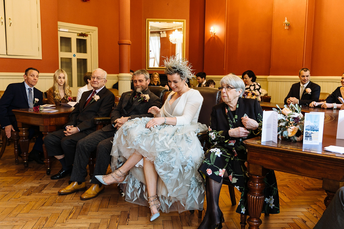 Emma and Marshy had a secret wedding in Brighton. Emma wore a bespoke blue dress by Suzanne Neville. Photography by Nick Tucker.