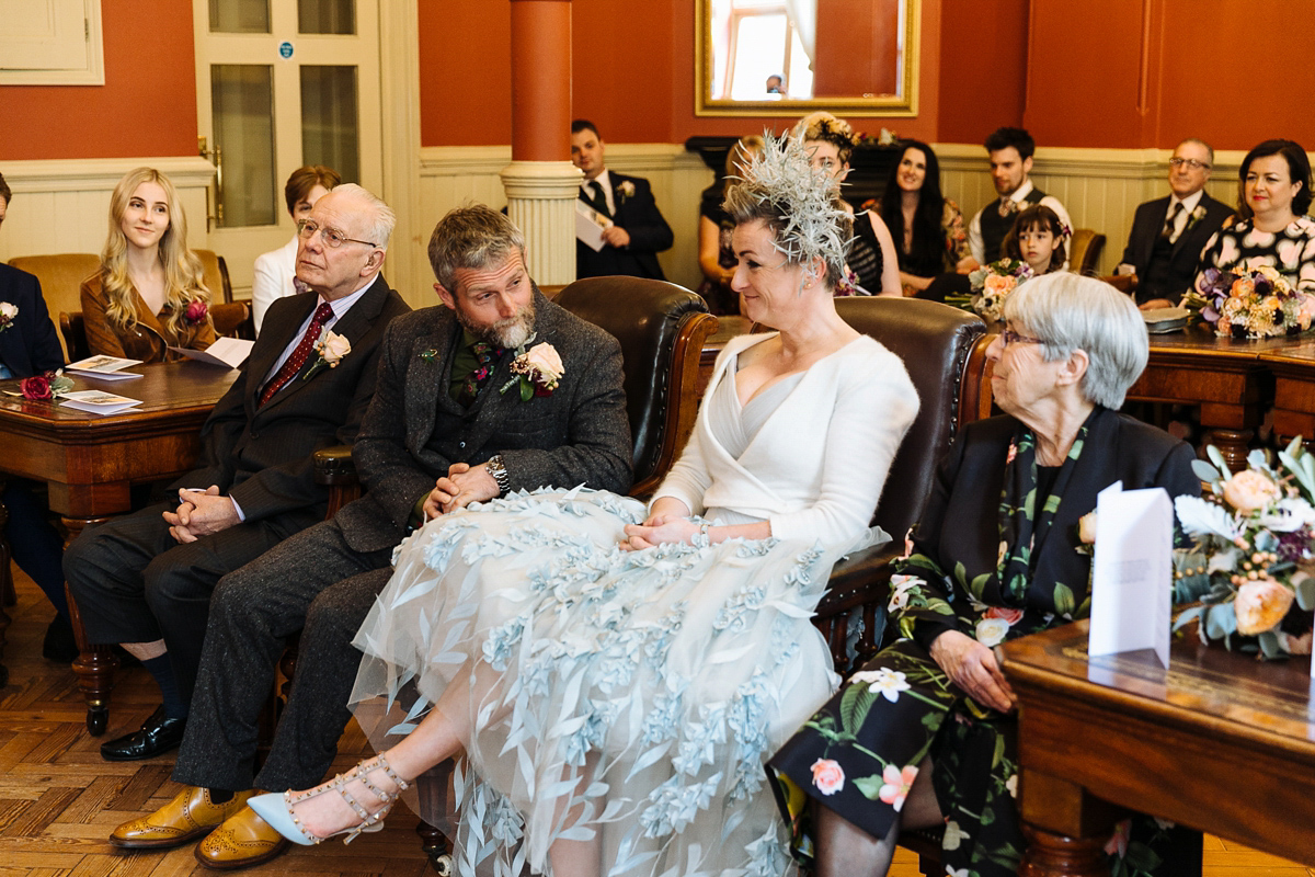 Emma and Marshy had a secret wedding in Brighton. Emma wore a bespoke blue dress by Suzanne Neville. Photography by Nick Tucker.