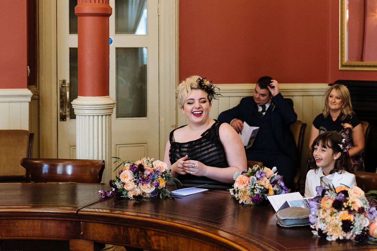 Emma and Marshy had a secret wedding in Brighton. Emma wore a bespoke blue dress by Suzanne Neville. Photography by Nick Tucker.