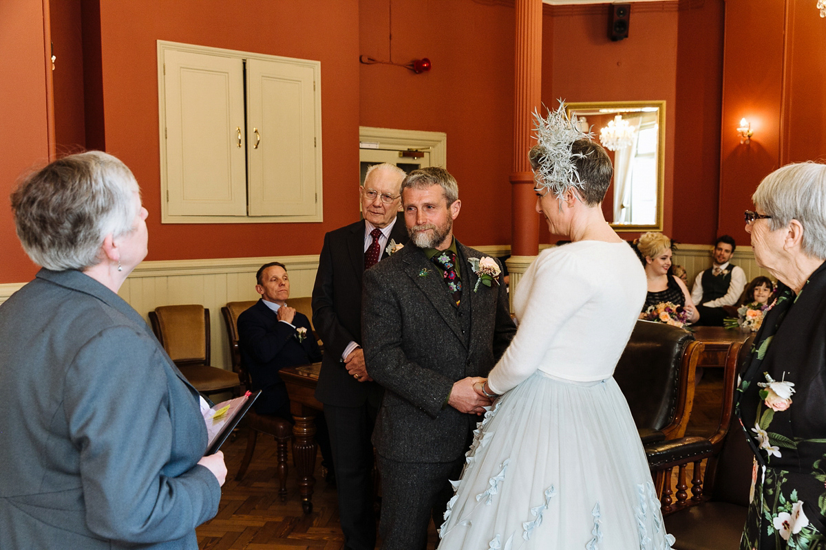 Emma and Marshy had a secret wedding in Brighton. Emma wore a bespoke blue dress by Suzanne Neville. Photography by Nick Tucker.