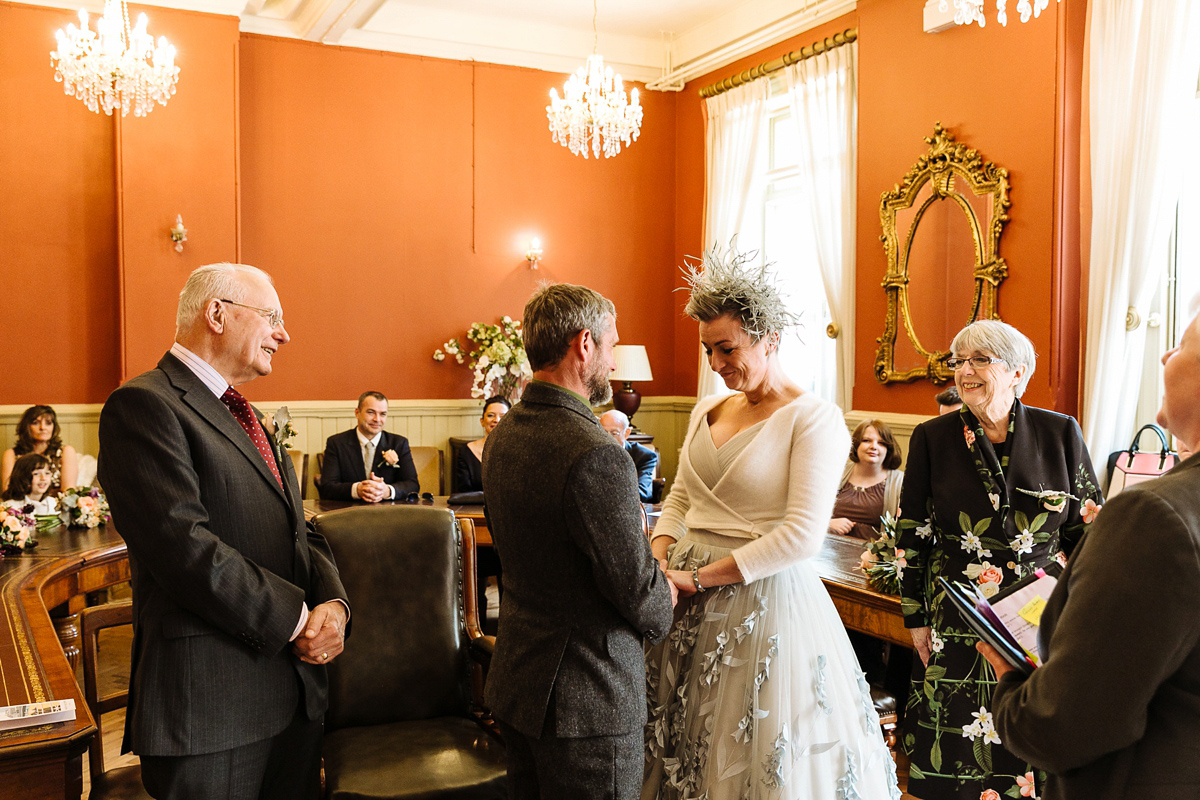 Emma and Marshy had a secret wedding in Brighton. Emma wore a bespoke blue dress by Suzanne Neville. Photography by Nick Tucker.