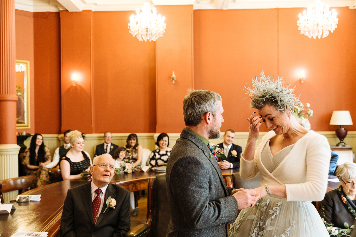 Emma and Marshy had a secret wedding in Brighton. Emma wore a bespoke blue dress by Suzanne Neville. Photography by Nick Tucker.