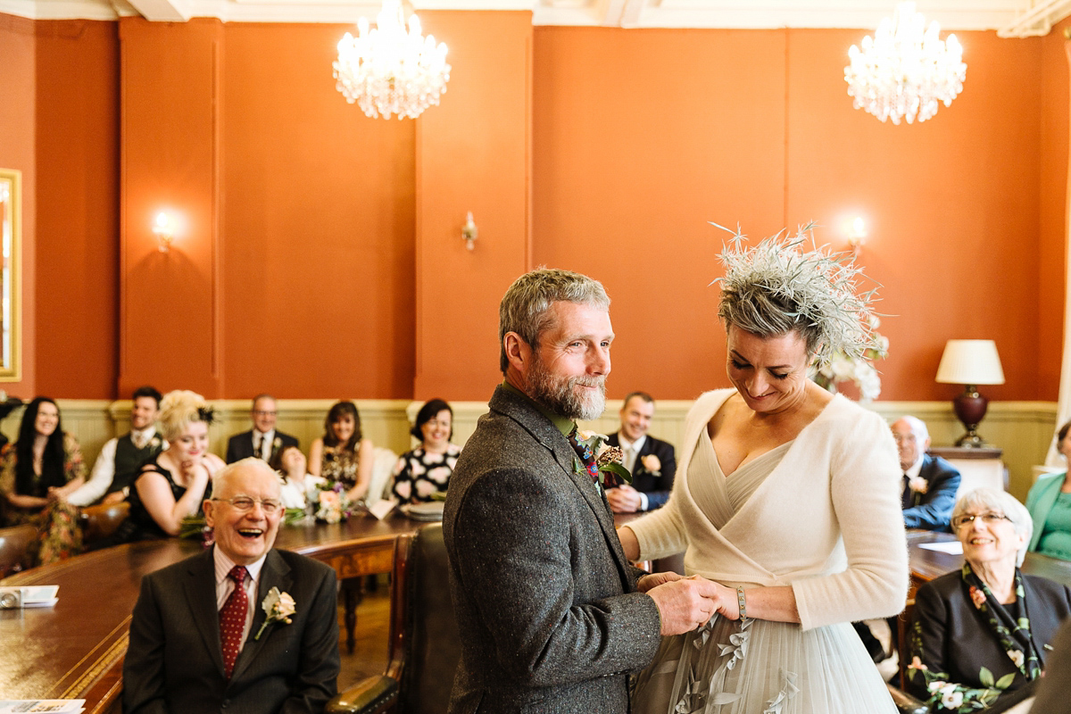 Emma and Marshy had a secret wedding in Brighton. Emma wore a bespoke blue dress by Suzanne Neville. Photography by Nick Tucker.