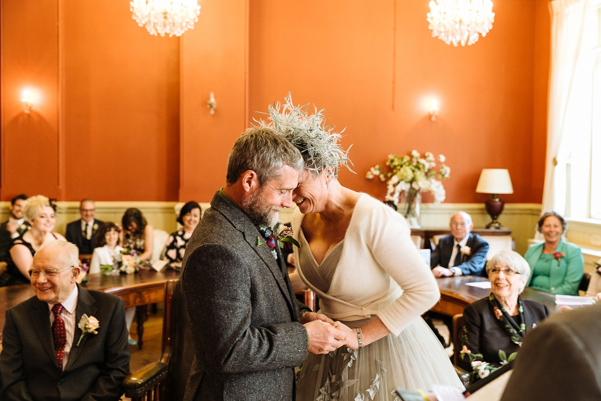 Emma and Marshy had a secret wedding in Brighton. Emma wore a bespoke blue dress by Suzanne Neville. Photography by Nick Tucker.