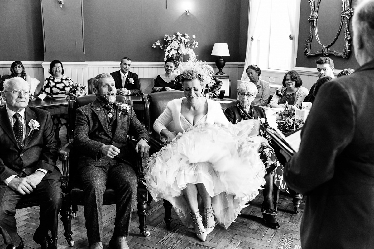 Emma and Marshy had a secret wedding in Brighton. Emma wore a bespoke blue dress by Suzanne Neville. Photography by Nick Tucker.