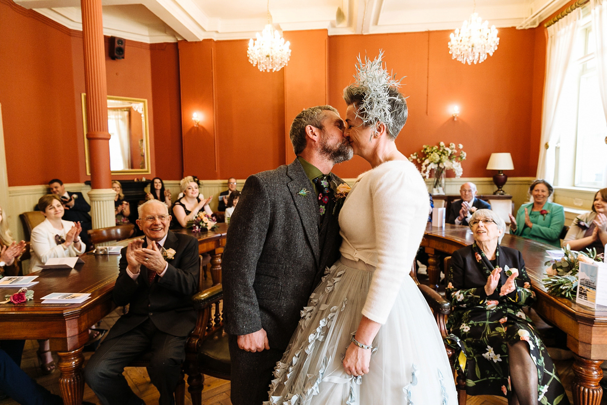 Emma and Marshy had a secret wedding in Brighton. Emma wore a bespoke blue dress by Suzanne Neville. Photography by Nick Tucker.