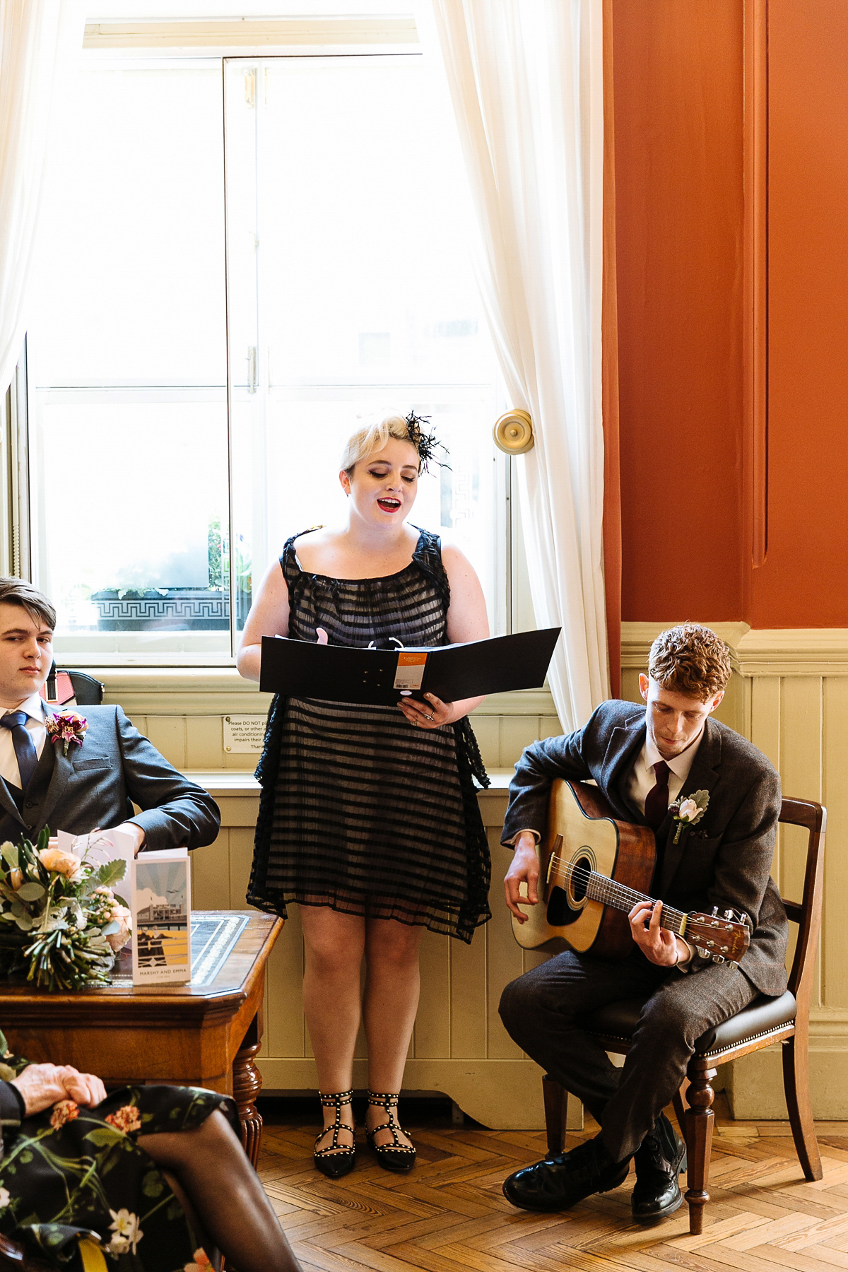 Emma and Marshy had a secret wedding in Brighton. Emma wore a bespoke blue dress by Suzanne Neville. Photography by Nick Tucker.