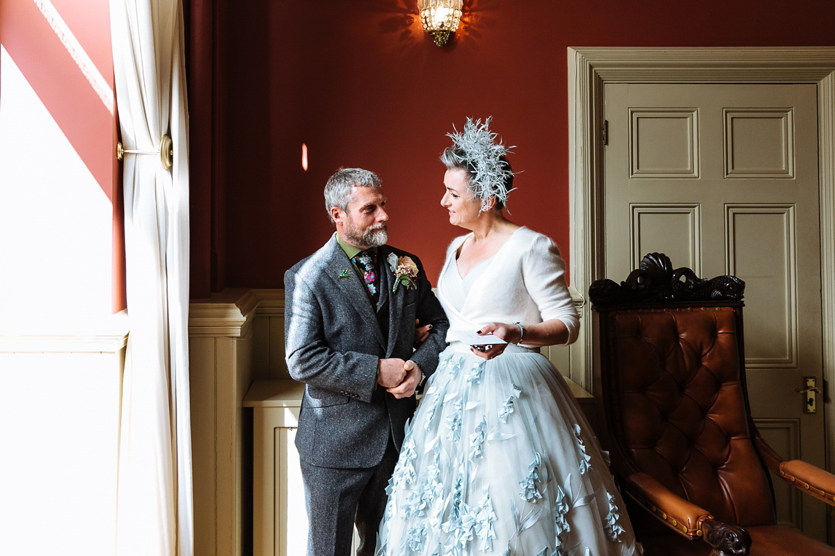 Emma and Marshy had a secret wedding in Brighton. Emma wore a bespoke blue dress by Suzanne Neville. Photography by Nick Tucker.