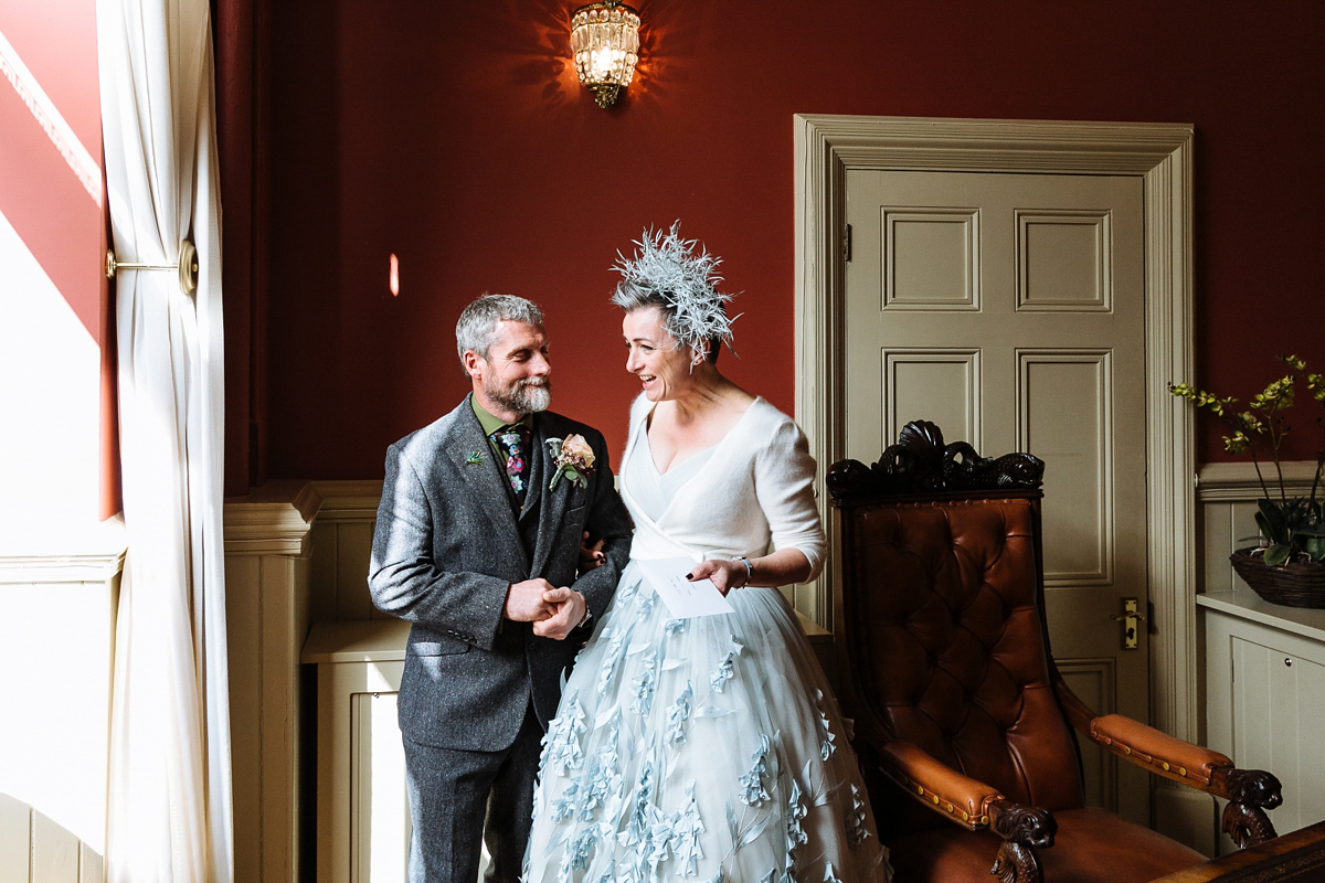 Emma and Marshy had a secret wedding in Brighton. Emma wore a bespoke blue dress by Suzanne Neville. Photography by Nick Tucker.