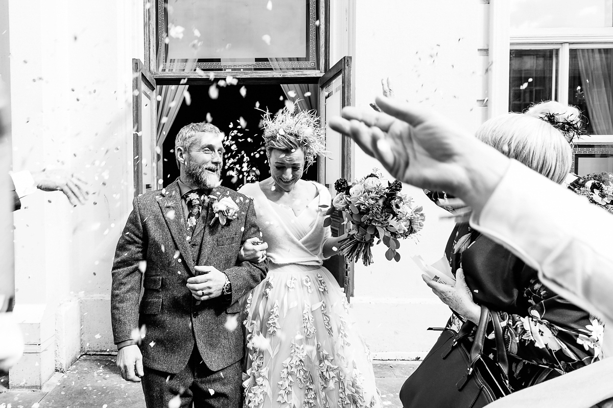 Emma and Marshy had a secret wedding in Brighton. Emma wore a bespoke blue dress by Suzanne Neville. Photography by Nick Tucker.