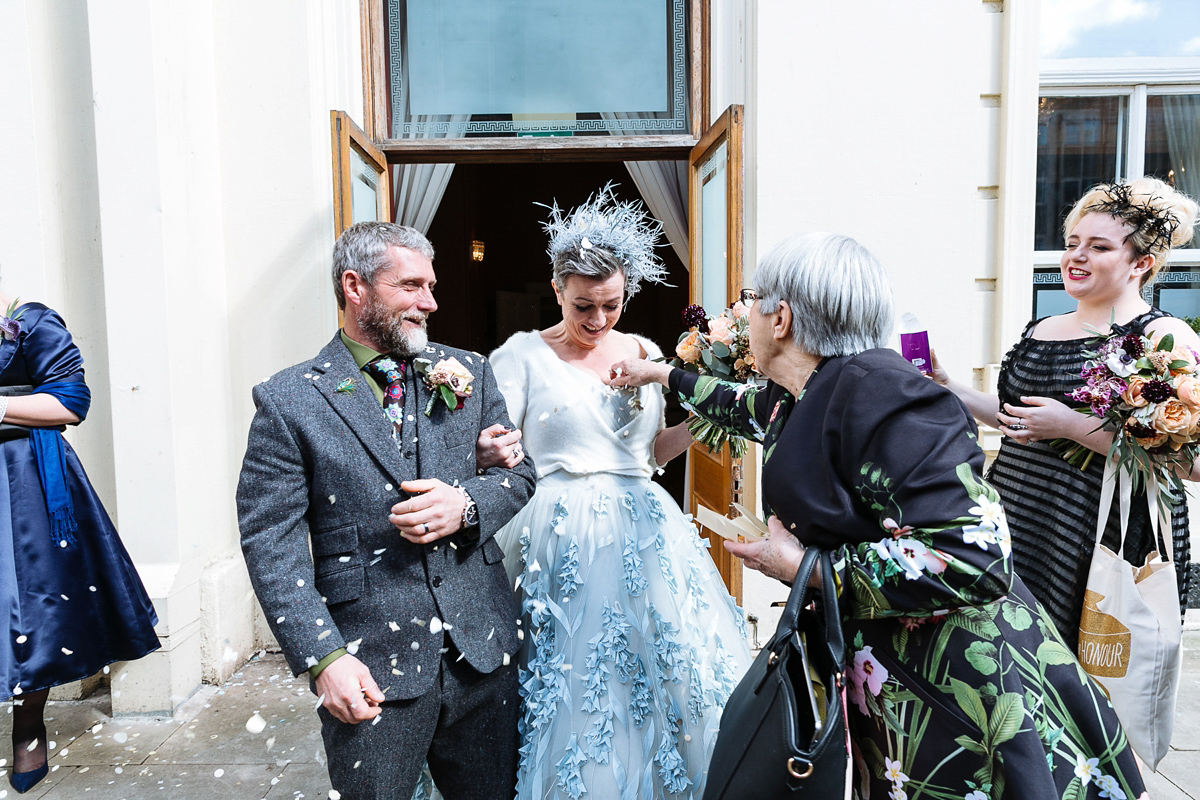 Emma and Marshy had a secret wedding in Brighton. Emma wore a bespoke blue dress by Suzanne Neville. Photography by Nick Tucker.