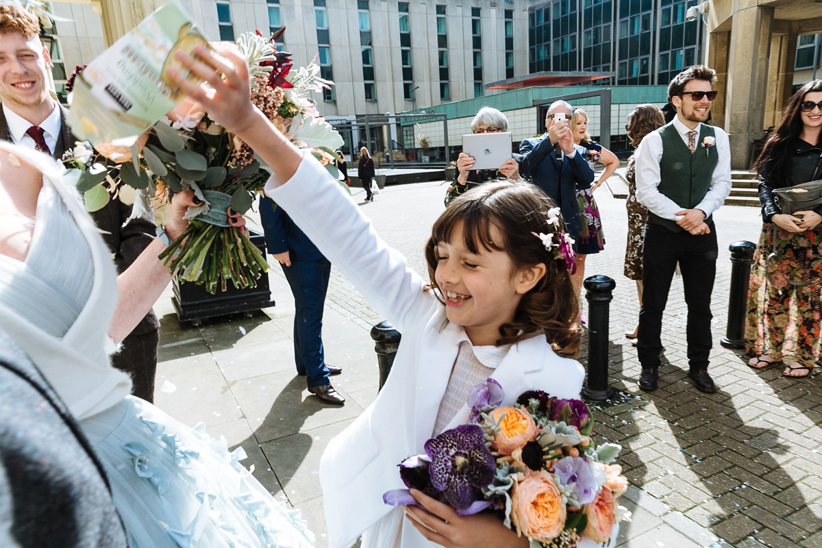 Emma and Marshy had a secret wedding in Brighton. Emma wore a bespoke blue dress by Suzanne Neville. Photography by Nick Tucker.