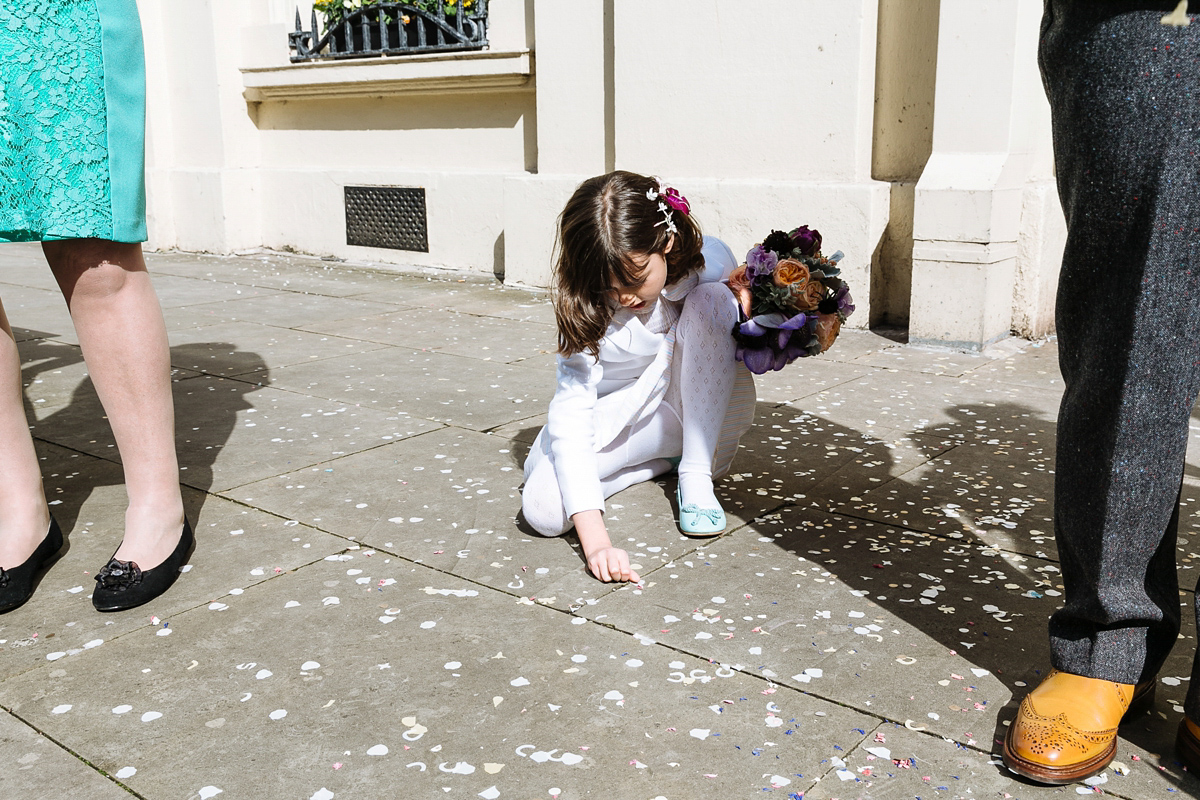 Emma and Marshy had a secret wedding in Brighton. Emma wore a bespoke blue dress by Suzanne Neville. Photography by Nick Tucker.