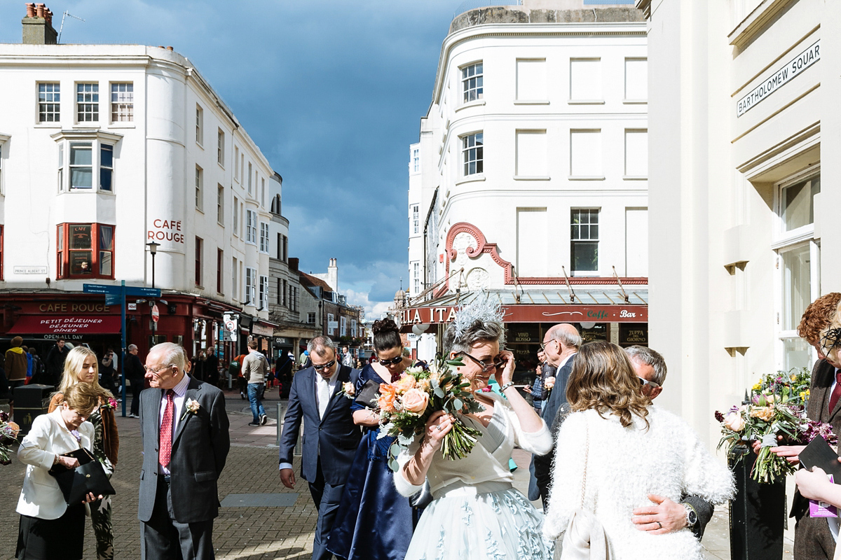 Emma and Marshy had a secret wedding in Brighton. Emma wore a bespoke blue dress by Suzanne Neville. Photography by Nick Tucker.