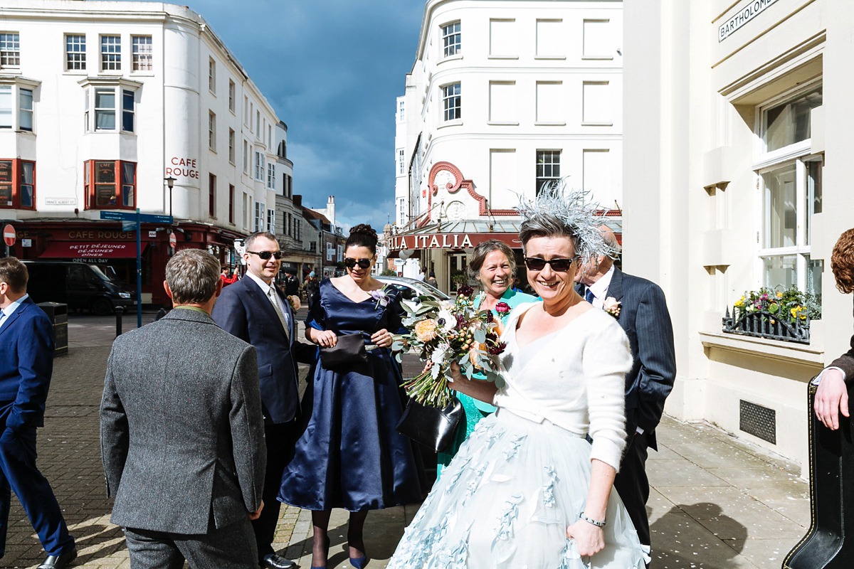 Emma and Marshy had a secret wedding in Brighton. Emma wore a bespoke blue dress by Suzanne Neville. Photography by Nick Tucker.