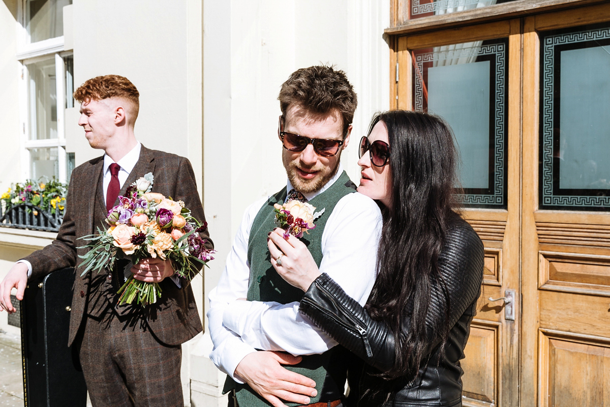 Emma and Marshy had a secret wedding in Brighton. Emma wore a bespoke blue dress by Suzanne Neville. Photography by Nick Tucker.