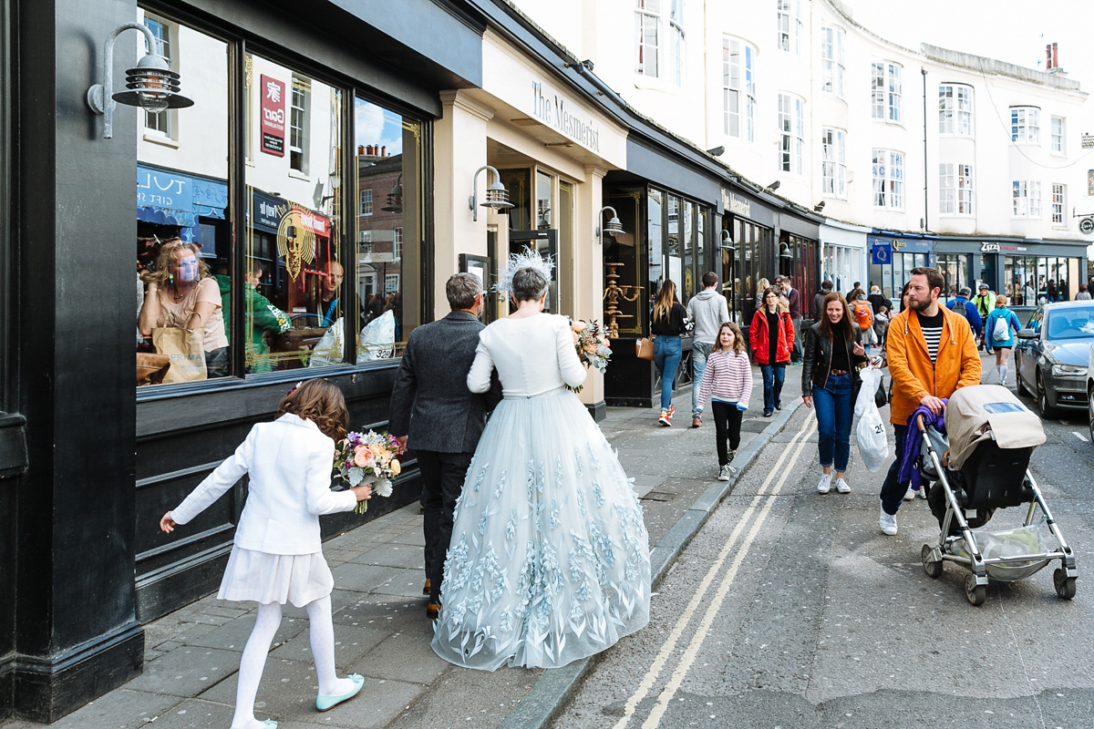 Emma and Marshy had a secret wedding in Brighton. Emma wore a bespoke blue dress by Suzanne Neville. Photography by Nick Tucker.