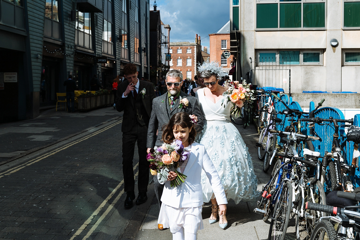 Emma and Marshy had a secret wedding in Brighton. Emma wore a bespoke blue dress by Suzanne Neville. Photography by Nick Tucker.