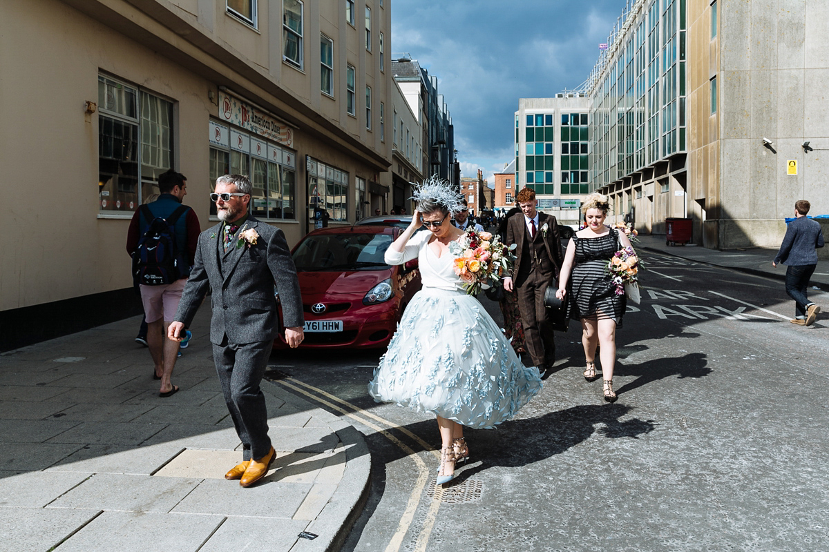 Emma and Marshy had a secret wedding in Brighton. Emma wore a bespoke blue dress by Suzanne Neville. Photography by Nick Tucker.