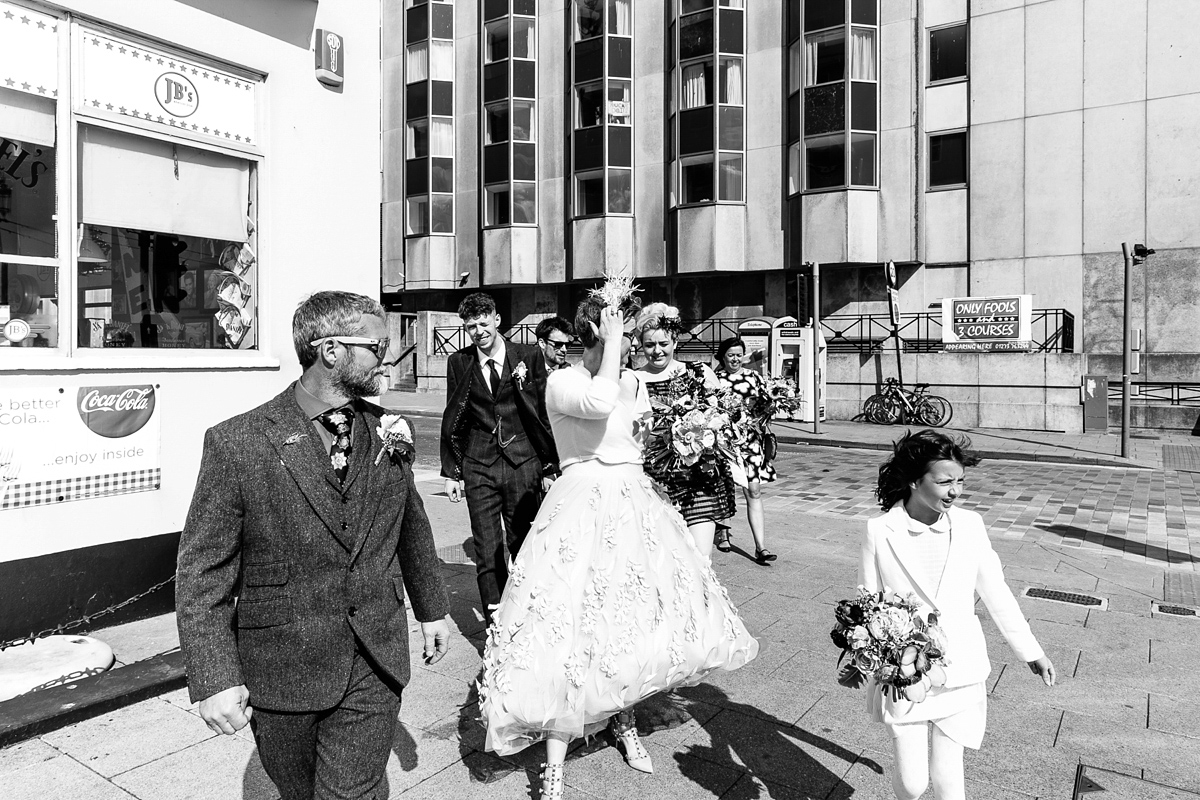 Emma and Marshy had a secret wedding in Brighton. Emma wore a bespoke blue dress by Suzanne Neville. Photography by Nick Tucker.