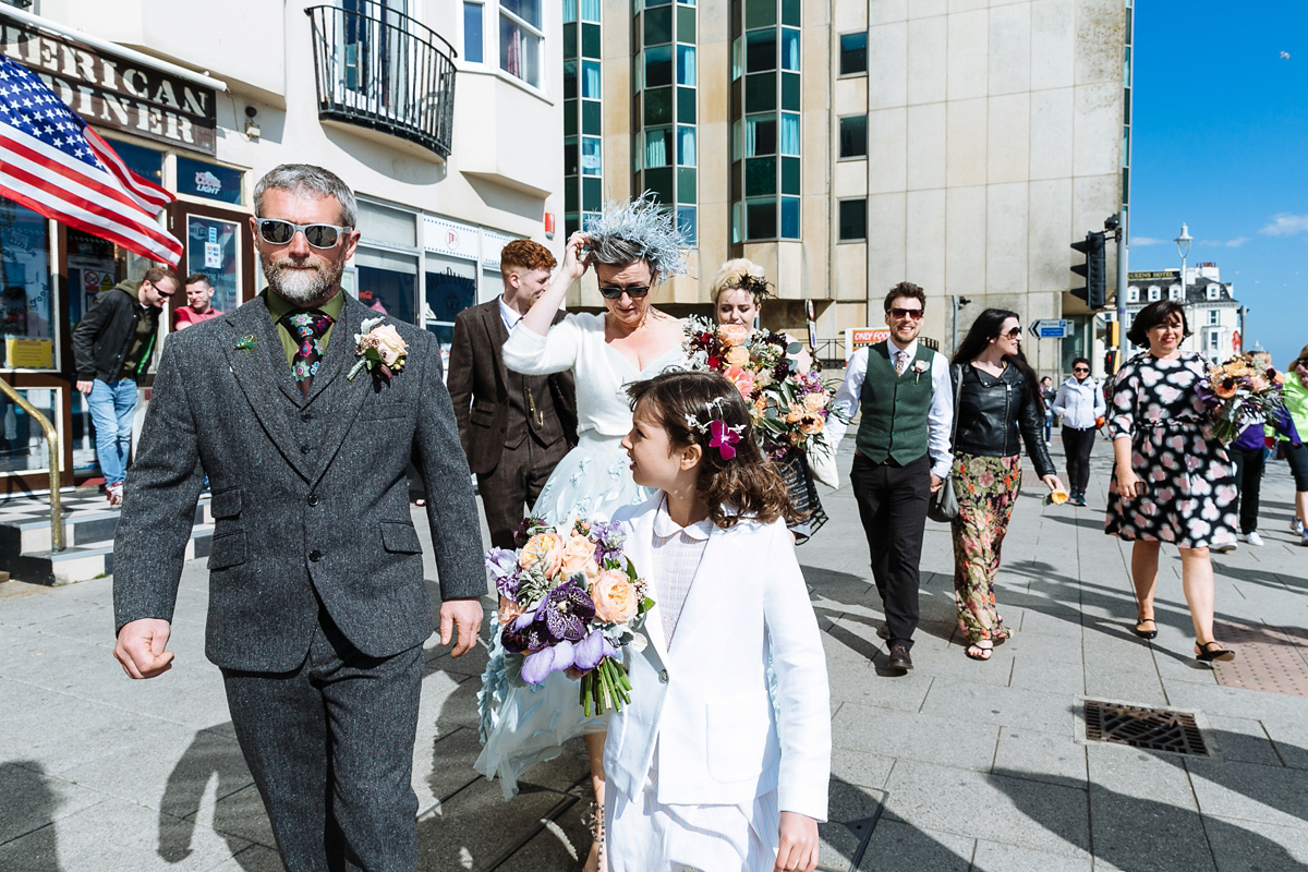 Emma and Marshy had a secret wedding in Brighton. Emma wore a bespoke blue dress by Suzanne Neville. Photography by Nick Tucker.