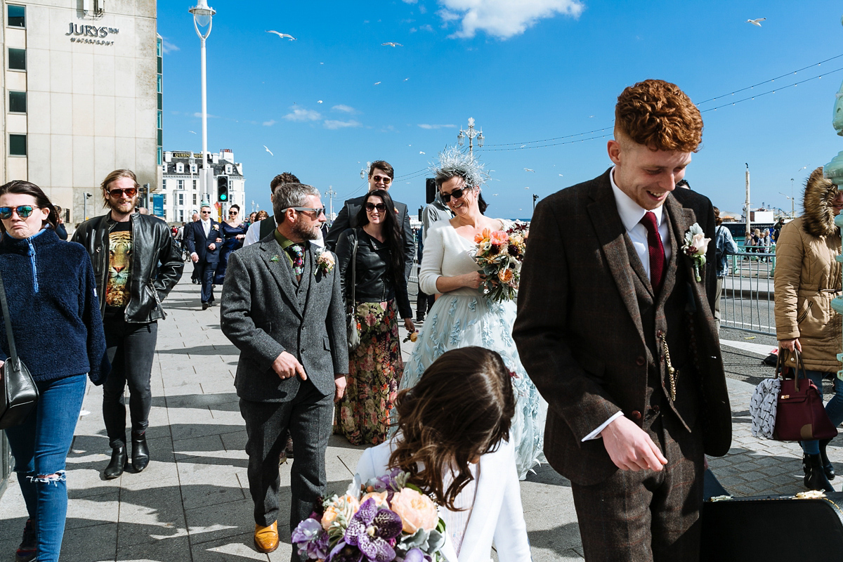 Emma and Marshy had a secret wedding in Brighton. Emma wore a bespoke blue dress by Suzanne Neville. Photography by Nick Tucker.