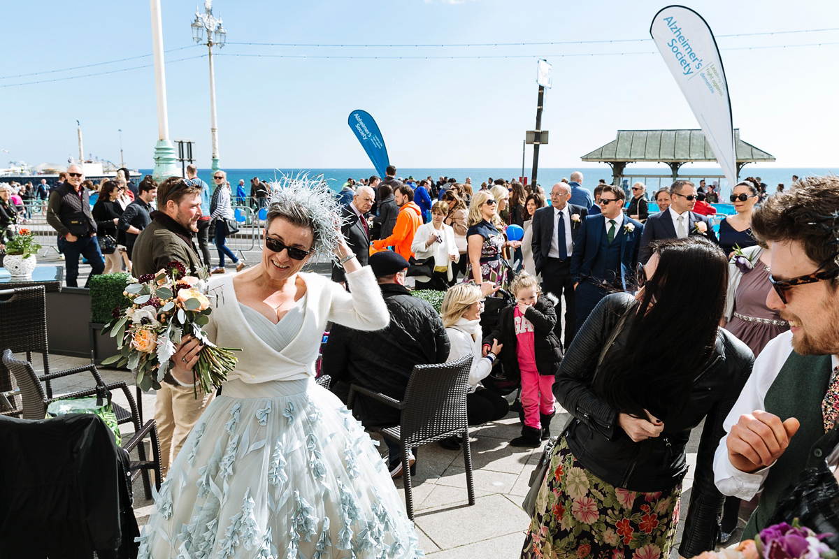 Emma and Marshy had a secret wedding in Brighton. Emma wore a bespoke blue dress by Suzanne Neville. Photography by Nick Tucker.