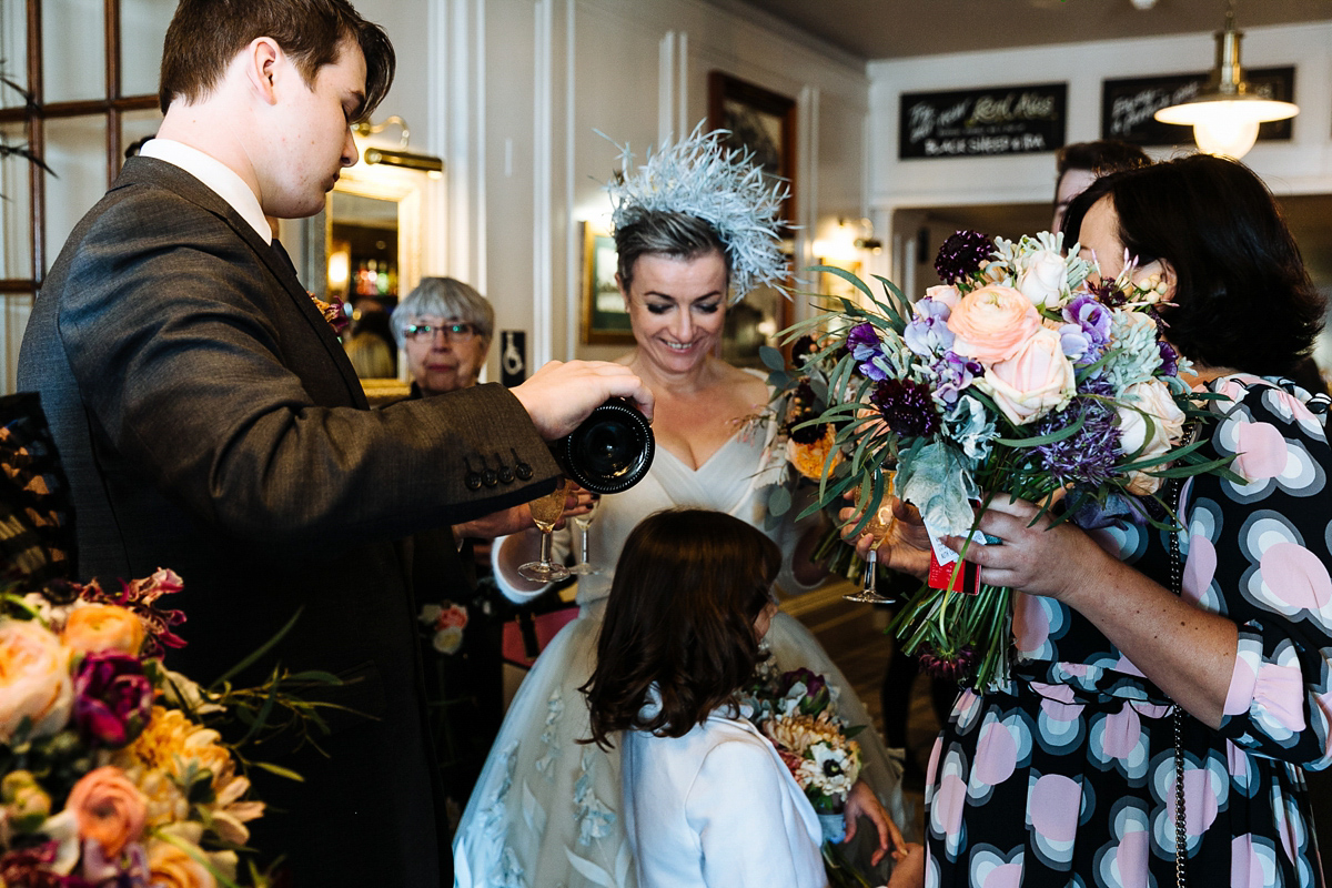 Emma and Marshy had a secret wedding in Brighton. Emma wore a bespoke blue dress by Suzanne Neville. Photography by Nick Tucker.