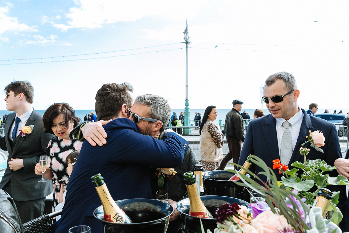 Emma and Marshy had a secret wedding in Brighton. Emma wore a bespoke blue dress by Suzanne Neville. Photography by Nick Tucker.