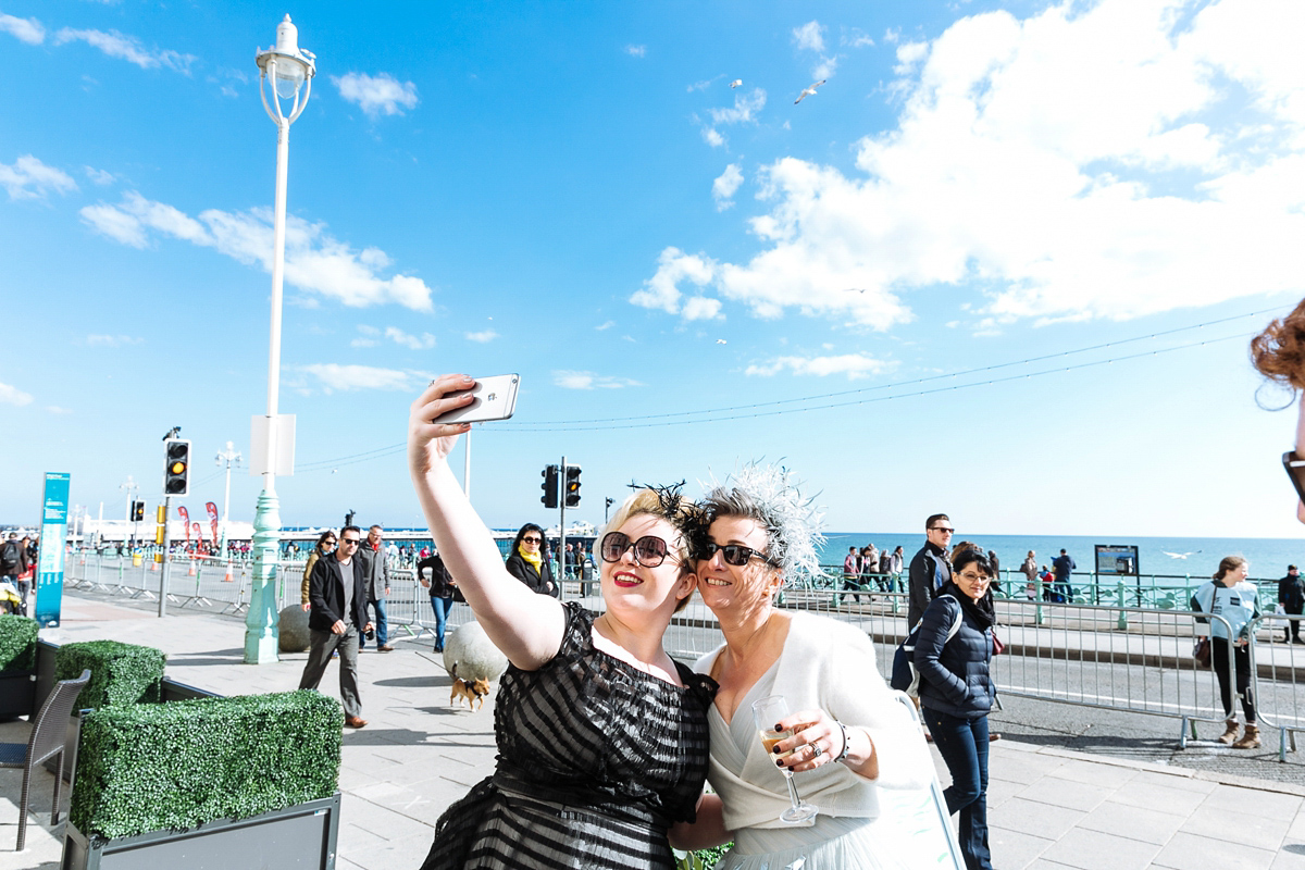 Emma and Marshy had a secret wedding in Brighton. Emma wore a bespoke blue dress by Suzanne Neville. Photography by Nick Tucker.