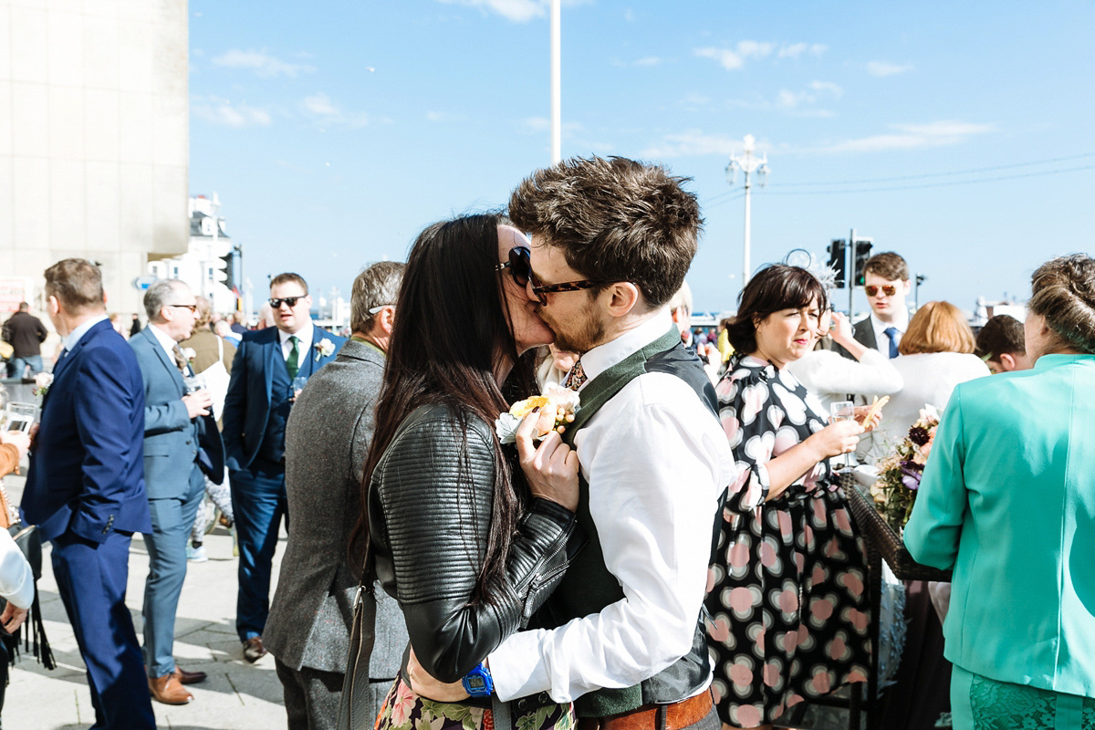 Emma and Marshy had a secret wedding in Brighton. Emma wore a bespoke blue dress by Suzanne Neville. Photography by Nick Tucker.