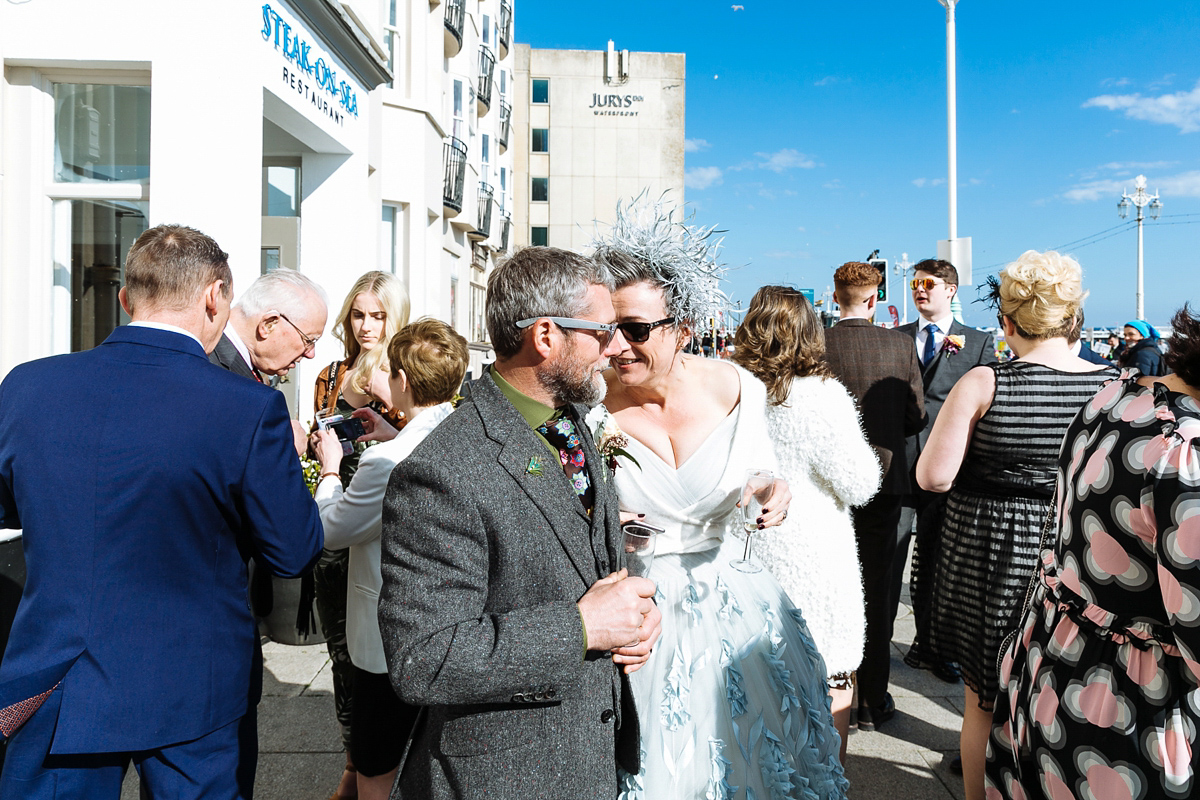 Emma and Marshy had a secret wedding in Brighton. Emma wore a bespoke blue dress by Suzanne Neville. Photography by Nick Tucker.