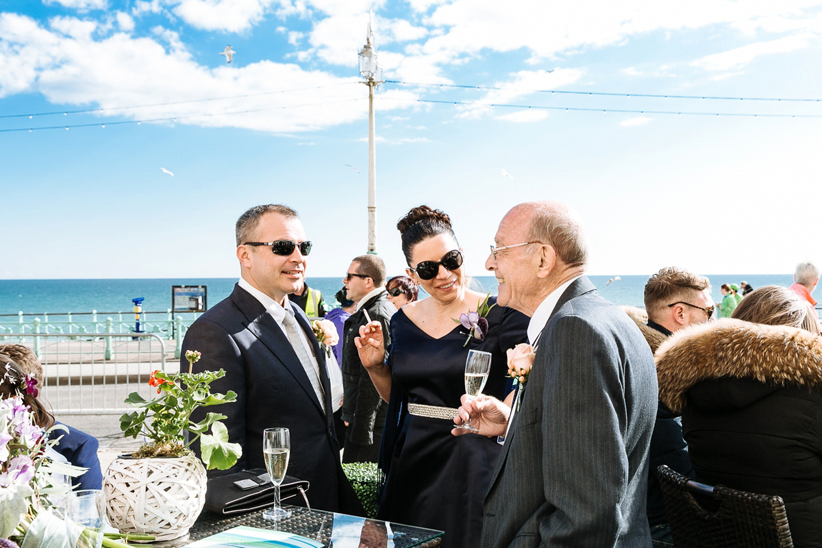 Emma and Marshy had a secret wedding in Brighton. Emma wore a bespoke blue dress by Suzanne Neville. Photography by Nick Tucker.