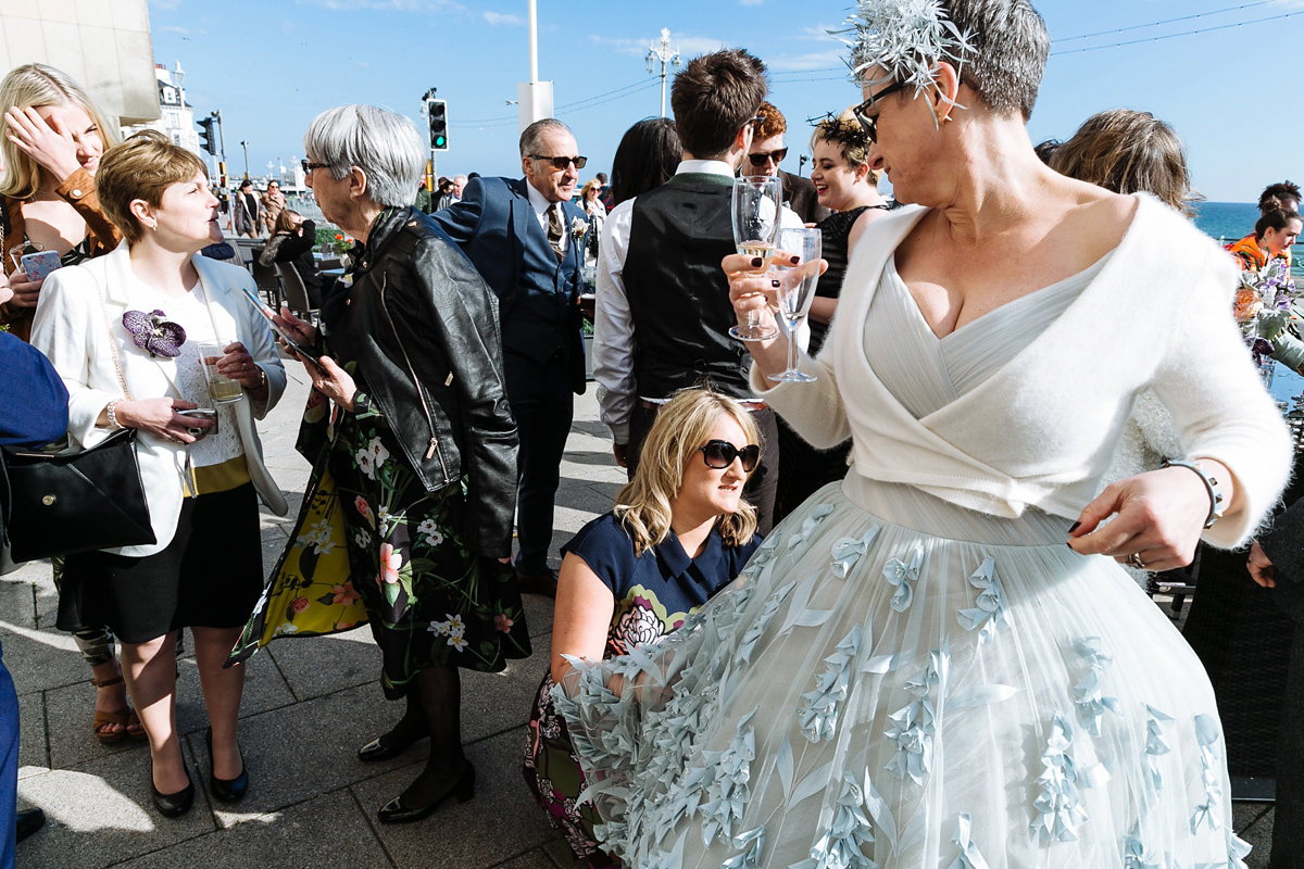 Emma and Marshy had a secret wedding in Brighton. Emma wore a bespoke blue dress by Suzanne Neville. Photography by Nick Tucker.