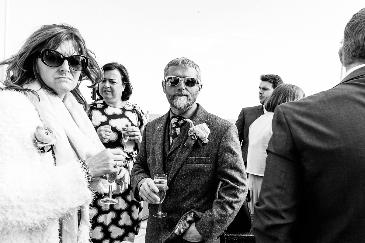 Emma and Marshy had a secret wedding in Brighton. Emma wore a bespoke blue dress by Suzanne Neville. Photography by Nick Tucker.