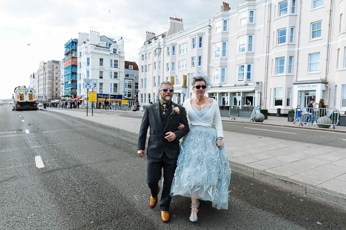 Emma and Marshy had a secret wedding in Brighton. Emma wore a bespoke blue dress by Suzanne Neville. Photography by Nick Tucker.