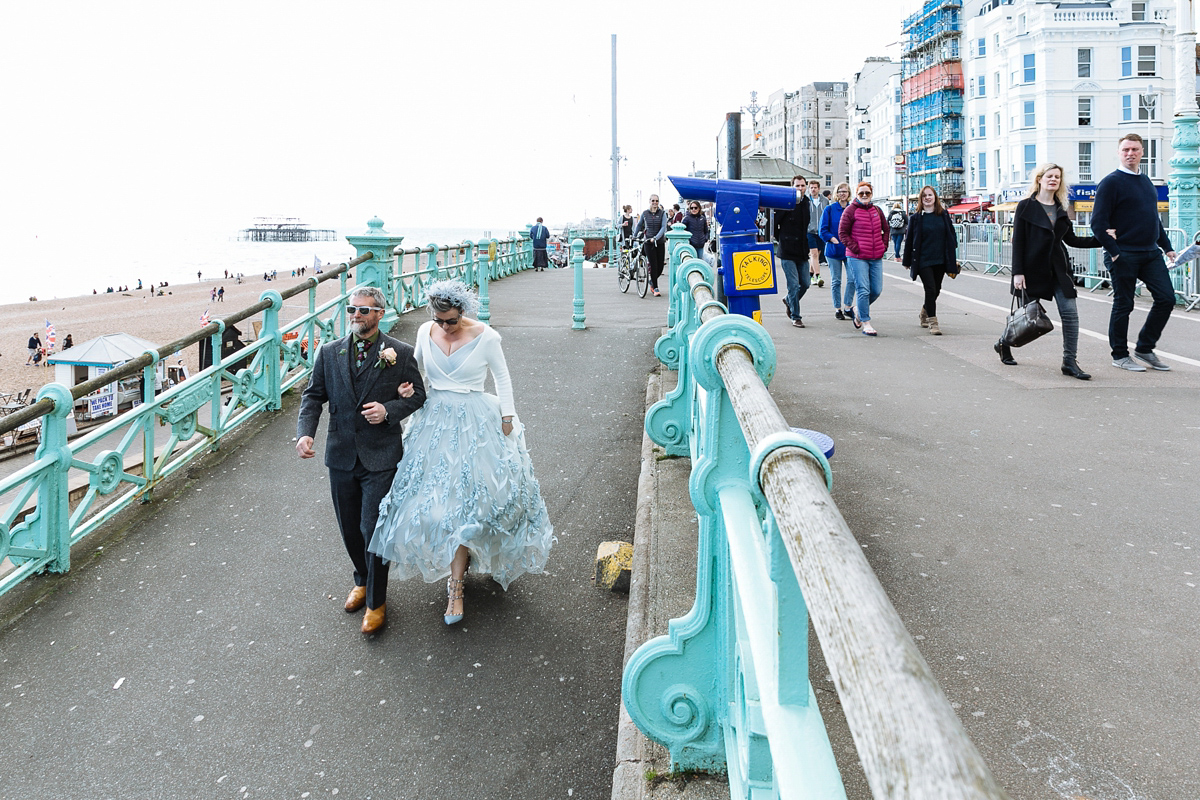 Emma and Marshy had a secret wedding in Brighton. Emma wore a bespoke blue dress by Suzanne Neville. Photography by Nick Tucker.