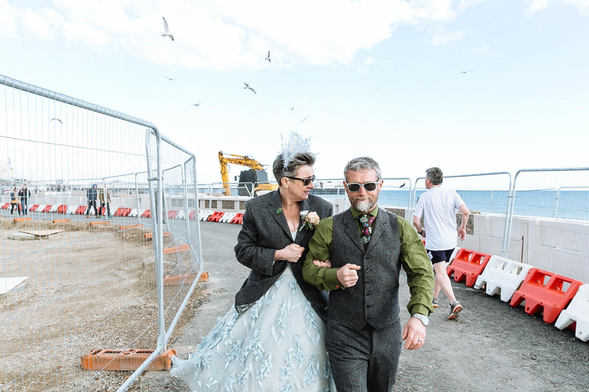 Emma and Marshy had a secret wedding in Brighton. Emma wore a bespoke blue dress by Suzanne Neville. Photography by Nick Tucker.