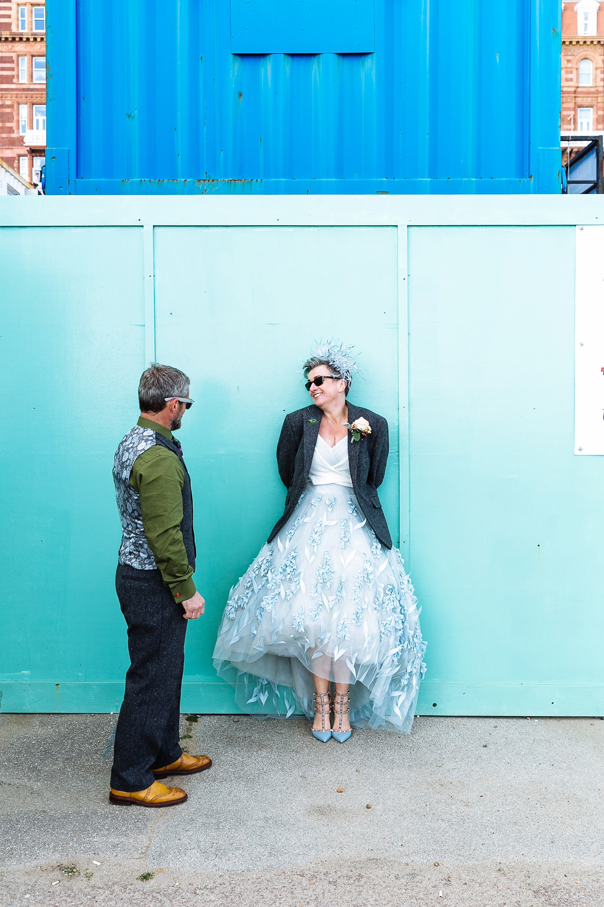 Emma and Marshy had a secret wedding in Brighton. Emma wore a bespoke blue dress by Suzanne Neville. Photography by Nick Tucker.