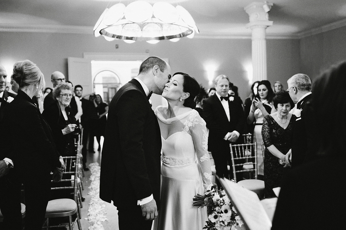 Antonietta wore a chic and elegant long sleeved Suzanne Neville gown for her black tie winter wedding at the RSA in London.